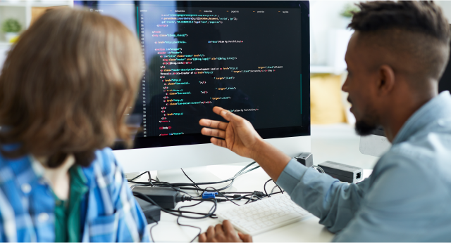 two software engineers working to upgrade banking software code