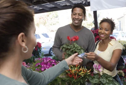 adult couple making a purchase at a flower market